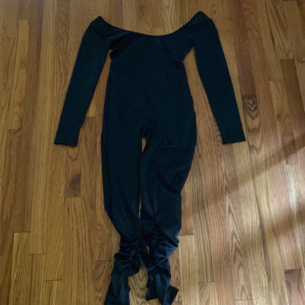 Black bodysuit that has the back open.